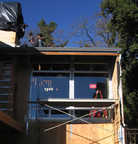 Living room windows. Above, the roofers...