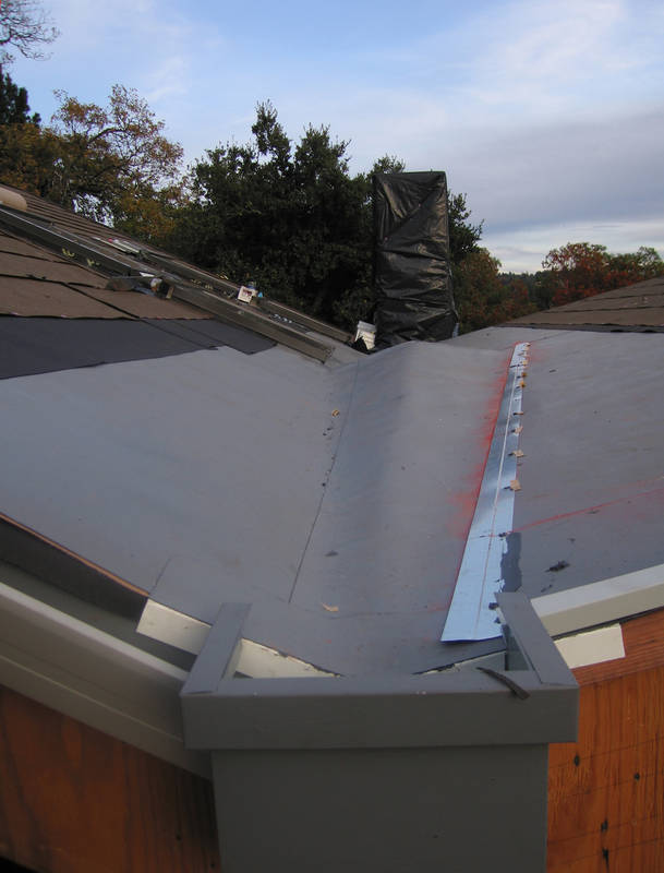 On the roof, the cricket is covered with...