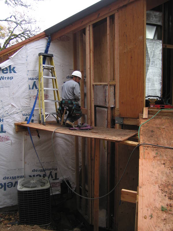 Valente works at framing in the A/C...