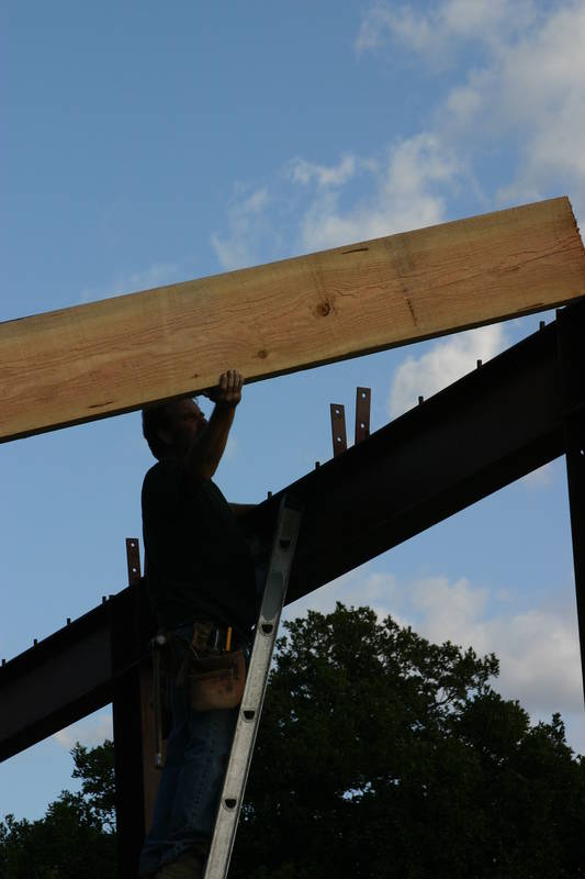 Dale guides the rafer into the bracket...