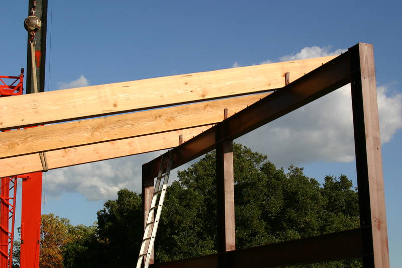 The crane supports the last rafter while...